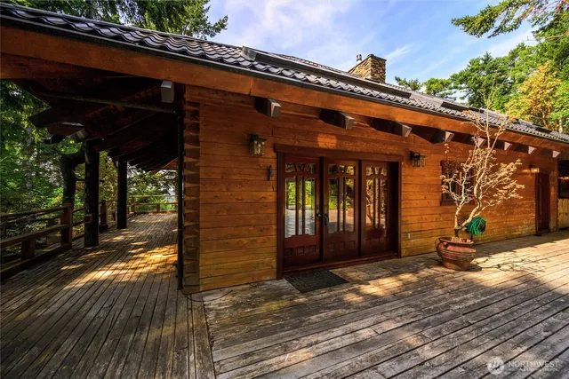 a view of balcony with wooden floor and a garden