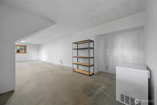 a backyard of a house with barbeque oven table and chairs