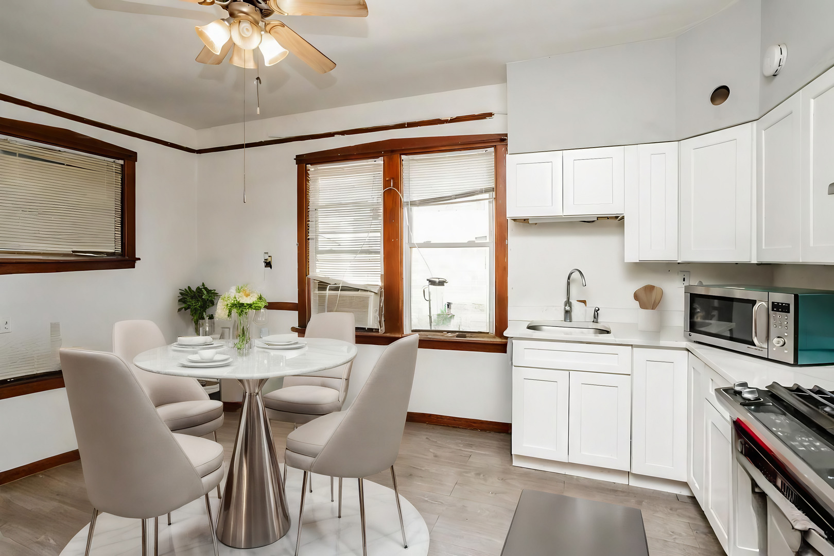 3108 West 54th Place Chicago, IL 60632 - Photo 3 of 7 a kitchen with stainless steel appliances a white table chairs and a refrigerator
