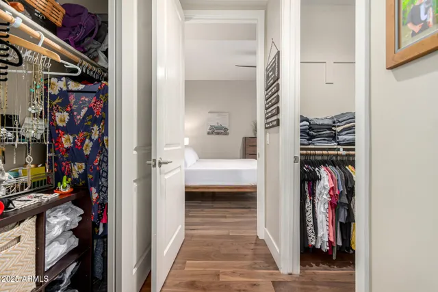 a view of walk in closet with clothes and shoes