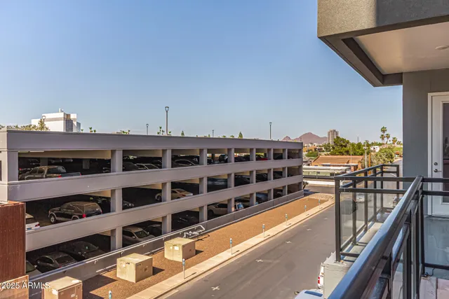 a roof deck with table and chairs