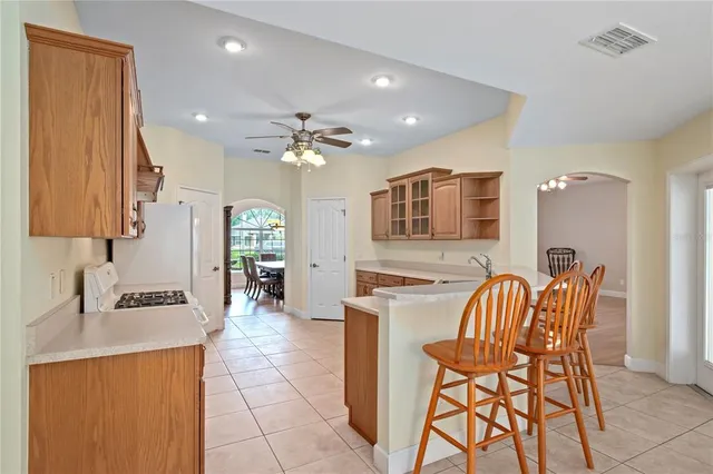 a kitchen with a stove top oven sink and cabinets