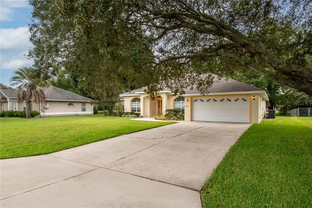 a front view of a house with a yard and a garage