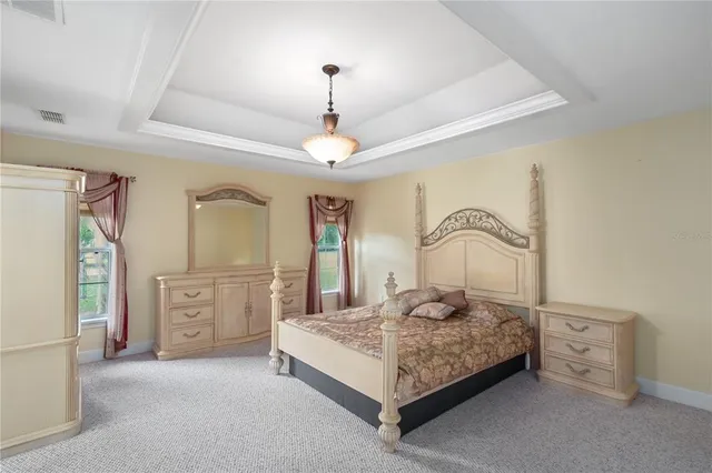 a bedroom with a bed and ceiling fan