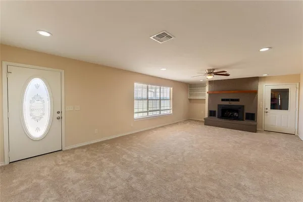 a living room with a fireplace and a television