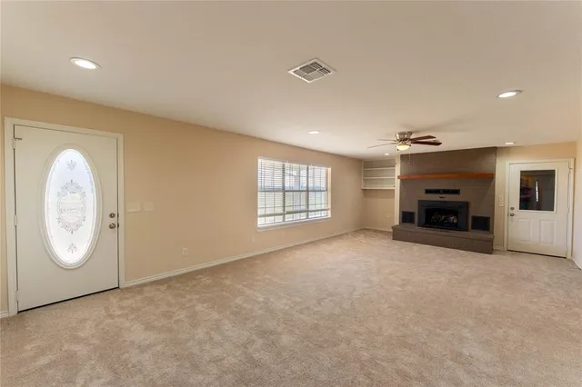 a living room with a fireplace and a television