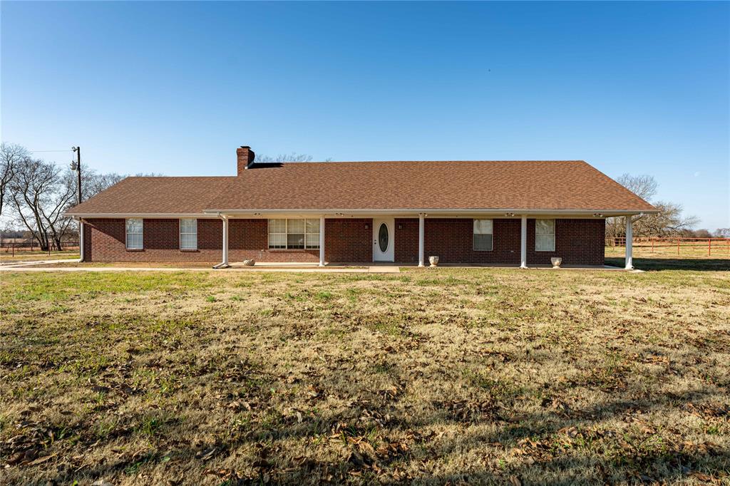 2573 Tbd Farm Road Clarksville, TX 75426 - Photo 6 of 22 a front view of a house with a garden