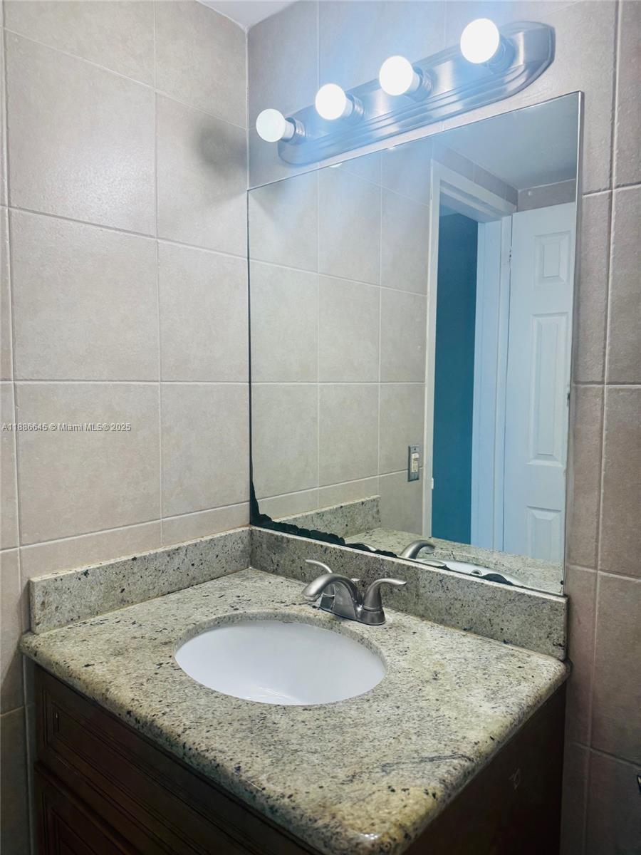 2000 Northeast 135th Street, Unit 403 North Miami, FL 33181 - Photo 11 of 23 Second Bathroom Face Basin with Solid Counter