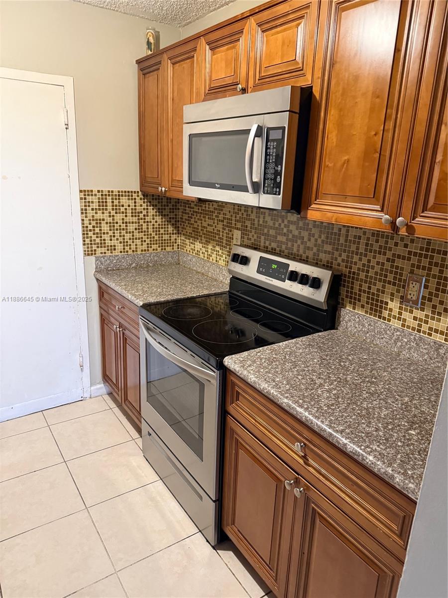 2000 Northeast 135th Street, Unit 403 North Miami, FL 33181 - Photo 2 of 23 Kitchen - Solid Counters & Tiled Floors