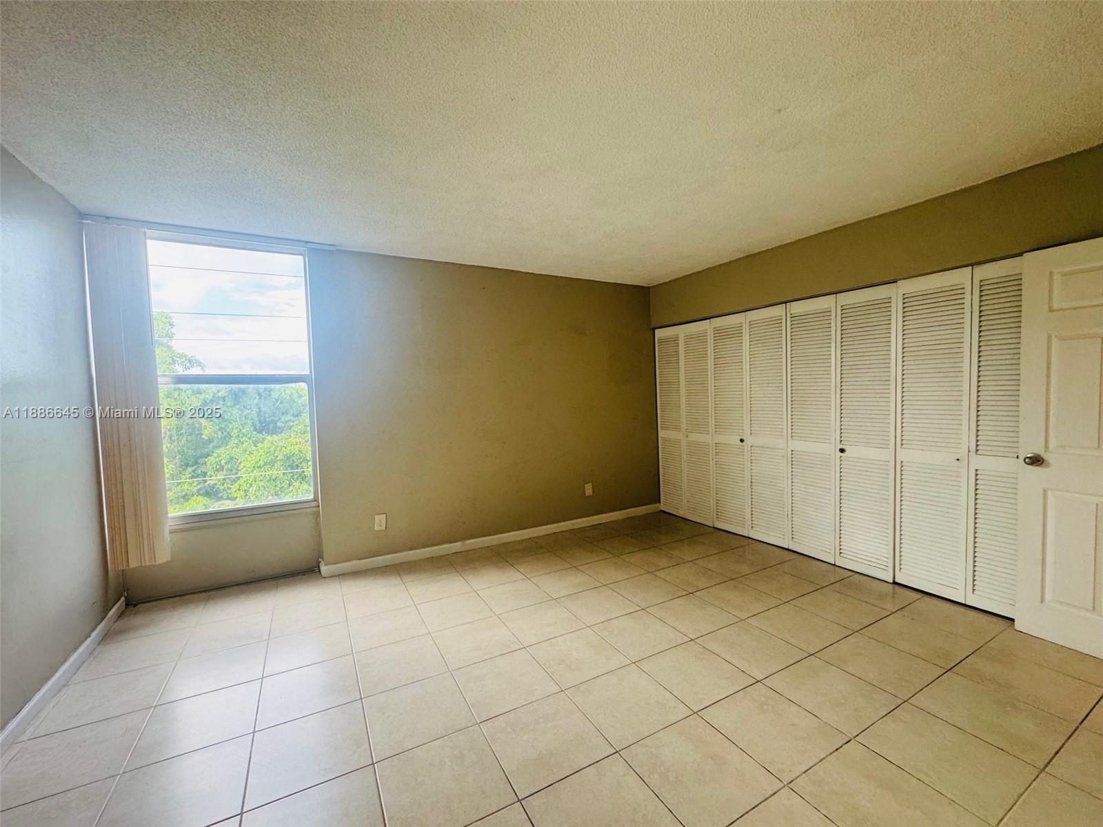 2000 Northeast 135th Street, Unit 403 North Miami, FL 33181 - Photo 7 of 23 Master Bedroom with Full Wall Closet