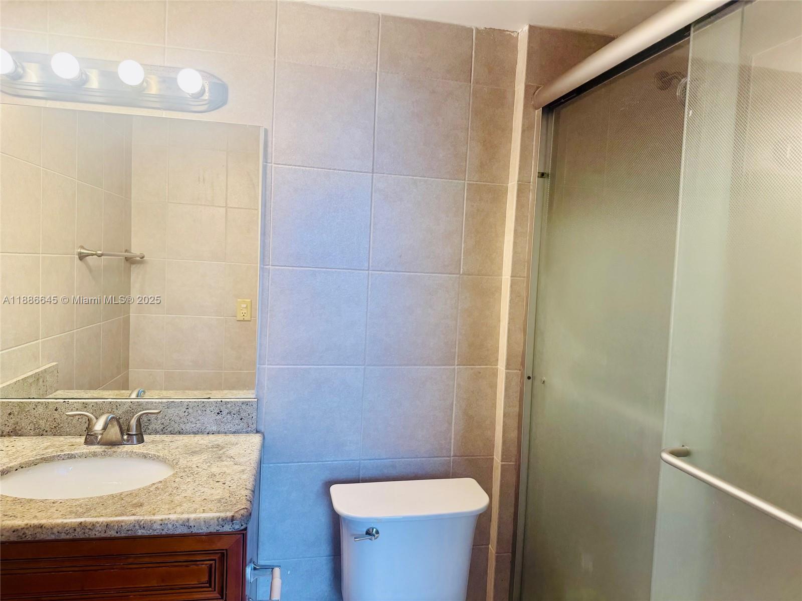 2000 Northeast 135th Street, Unit 403 North Miami, FL 33181 - Photo 8 of 23 Master Bath with Glass Enclosed Shower