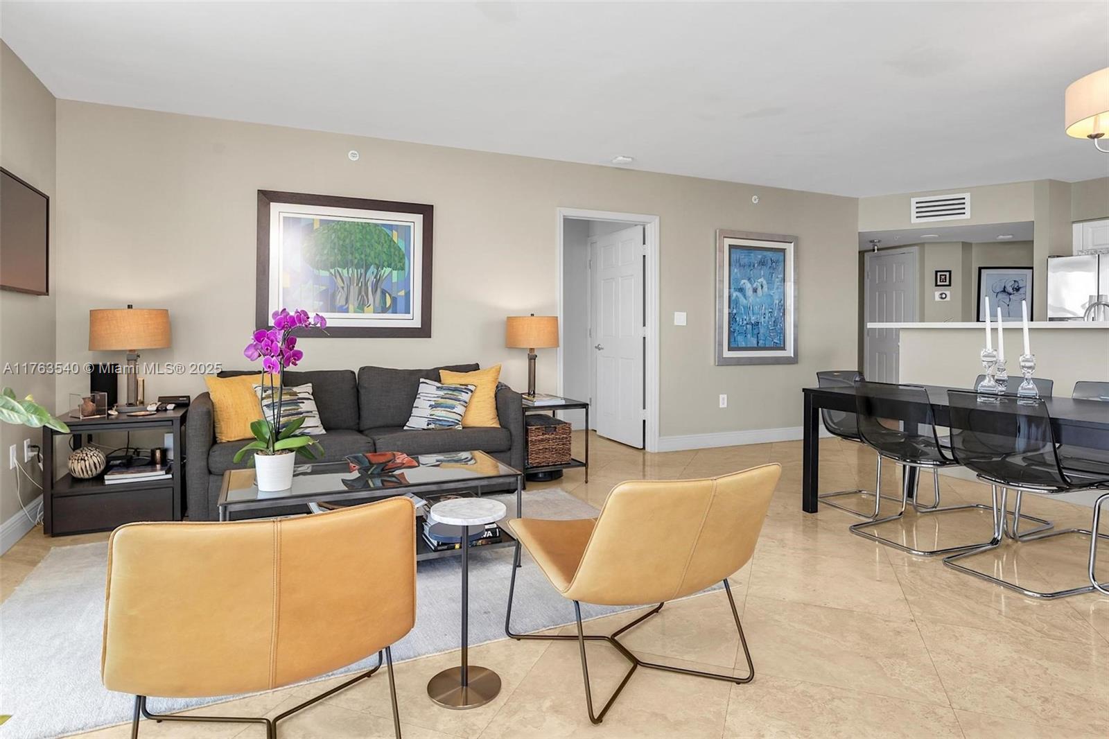 1155 Brickell Bay Drive, Unit 710 Miami, FL 33131 - Photo 11 of 32 a living room with furniture and a wooden floor