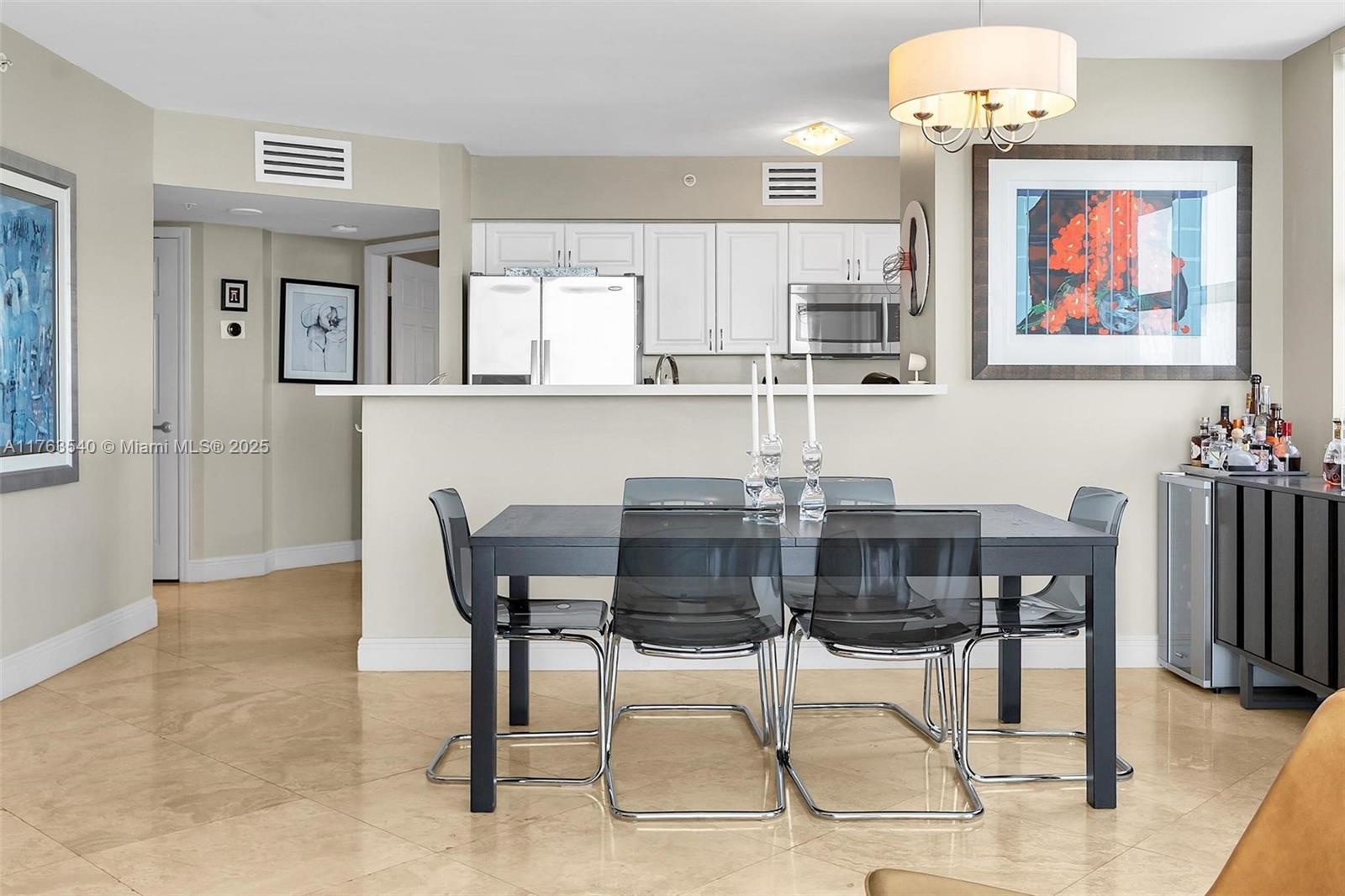 1155 Brickell Bay Drive, Unit 710 Miami, FL 33131 - Photo 14 of 32 a dining room with furniture and window