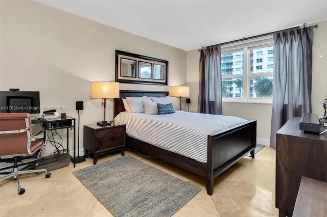 a living room with furniture a lamp and a flat screen tv