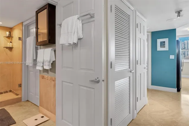 a bathroom with a granite countertop shower and a sink