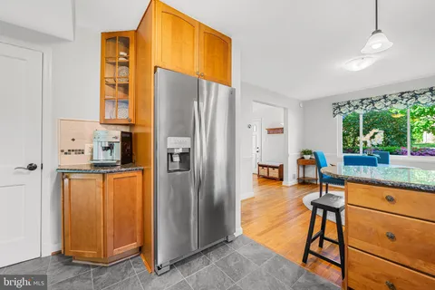 a kitchen with stainless steel appliances granite countertop a refrigerator and a stove top oven