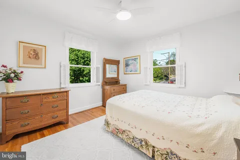 a spacious bedroom with a bed and a window