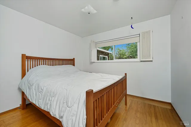 a bedroom with bed and window