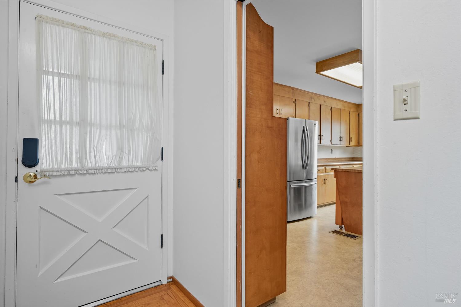 3735 Sacramento Avenue Santa Rosa, CA 95405 - Photo 3 of 24 a view of hallway with wooden floor and cabinet