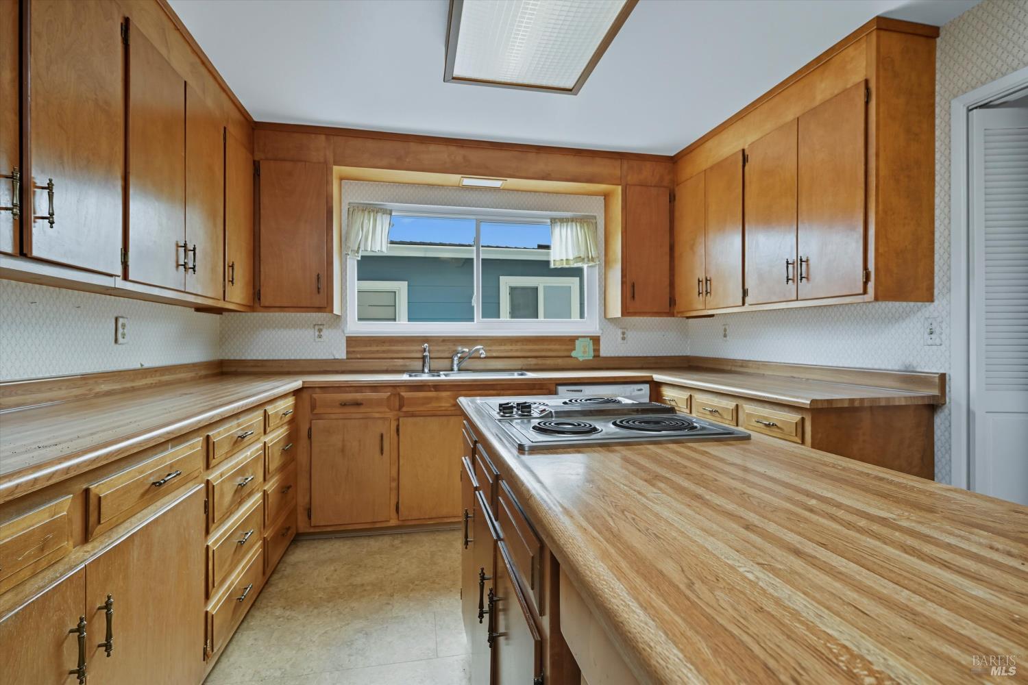 3735 Sacramento Avenue Santa Rosa, CA 95405 - Photo 5 of 24 a kitchen with a stove a sink and a microwave