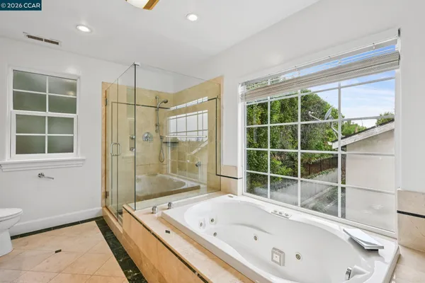 a bathroom with a bathtub and a shower