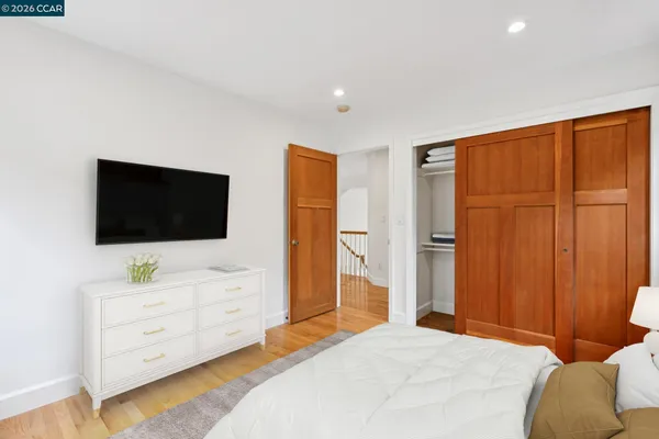 a bedroom with a bed and flat screen tv