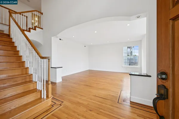 a view of a room with wooden floor and stairs
