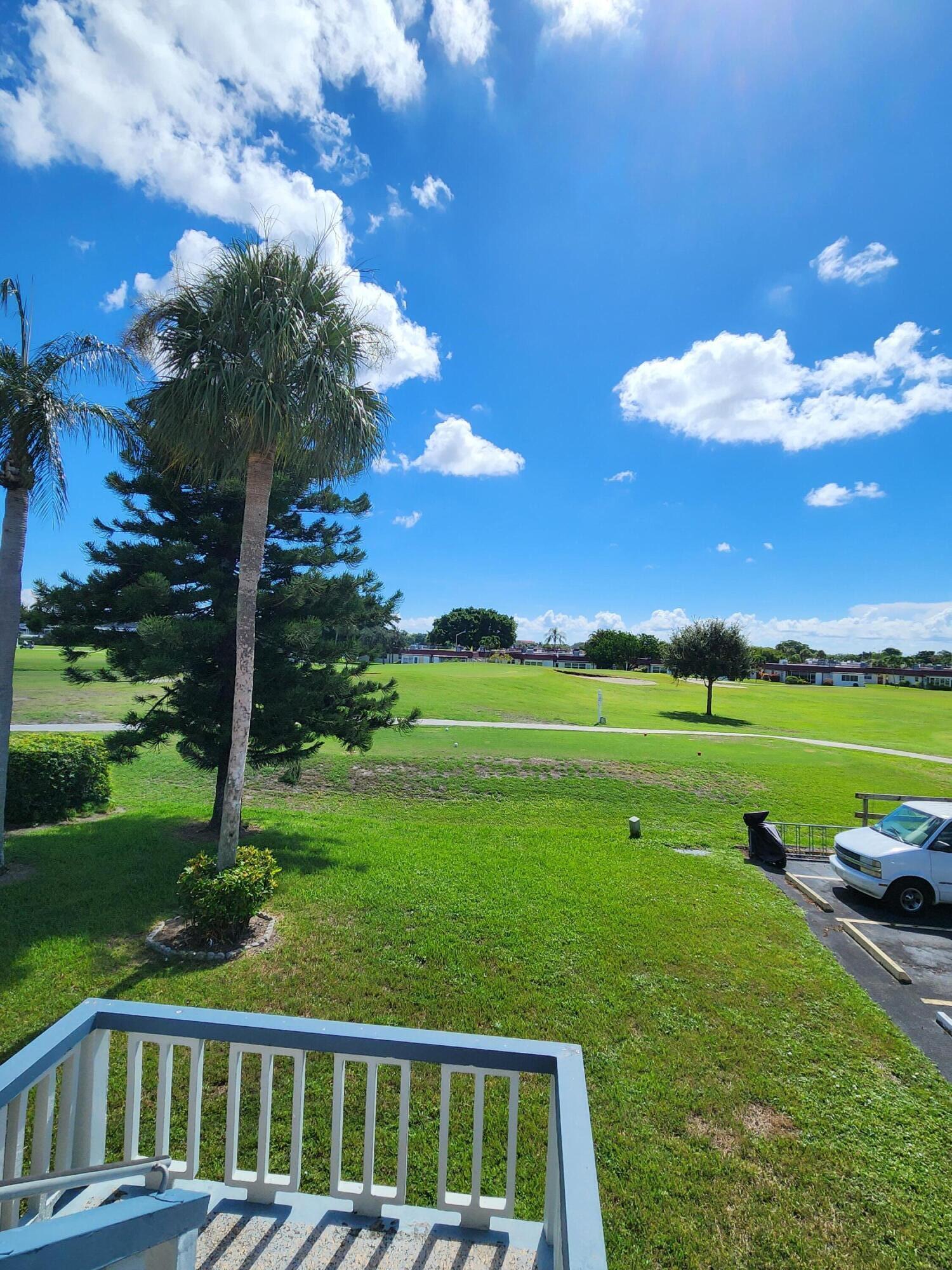 148 Tuscany Lane, Unit B Delray Beach, FL 33446 - Photo 11 of 11 a view of a golf course with a swimming pool