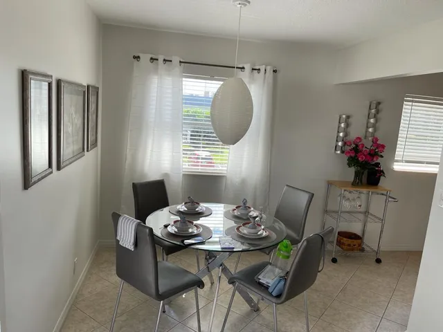 a view of a dining room with furniture and window