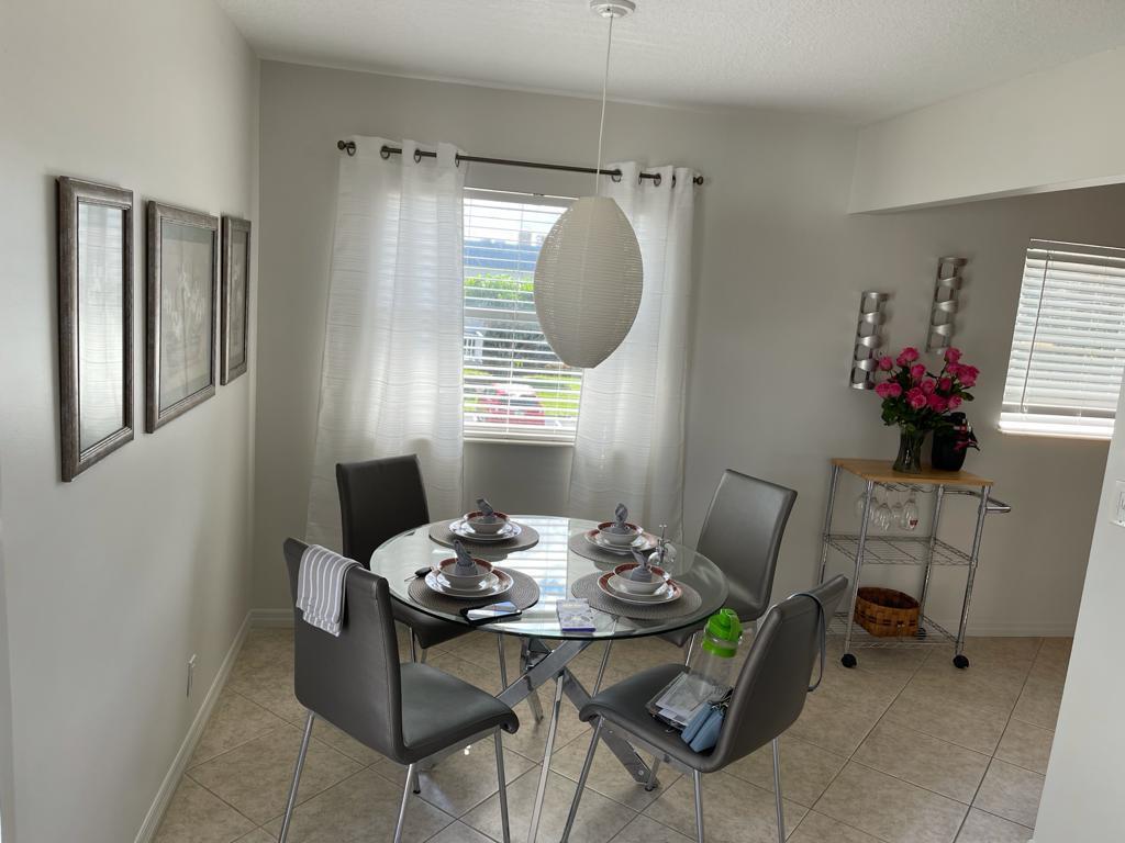 148 Tuscany Lane, Unit B Delray Beach, FL 33446 - Photo 2 of 11 a view of a dining room with furniture and window