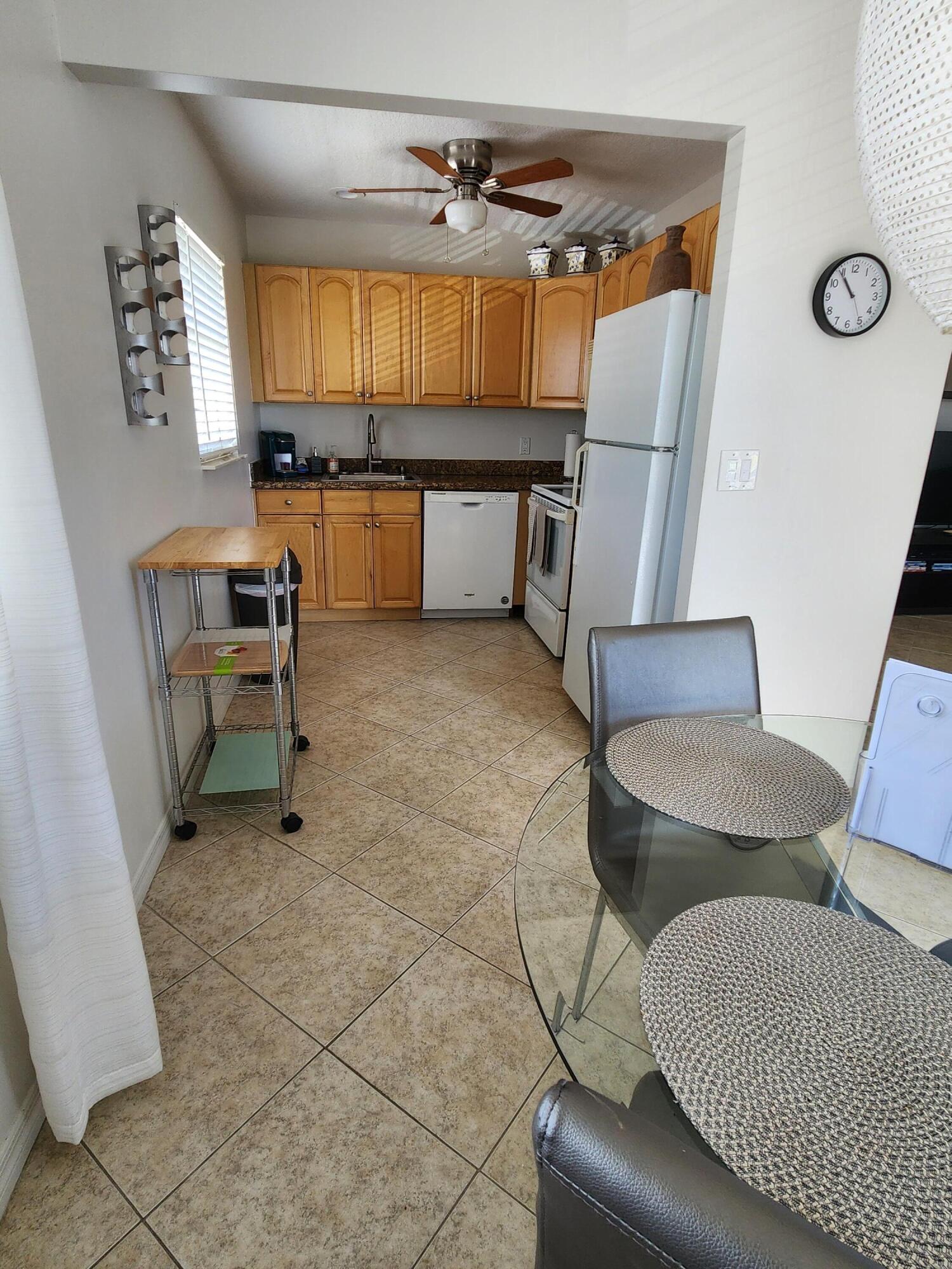 148 Tuscany Lane, Unit B Delray Beach, FL 33446 - Photo 3 of 11 a bedroom with furniture and a window