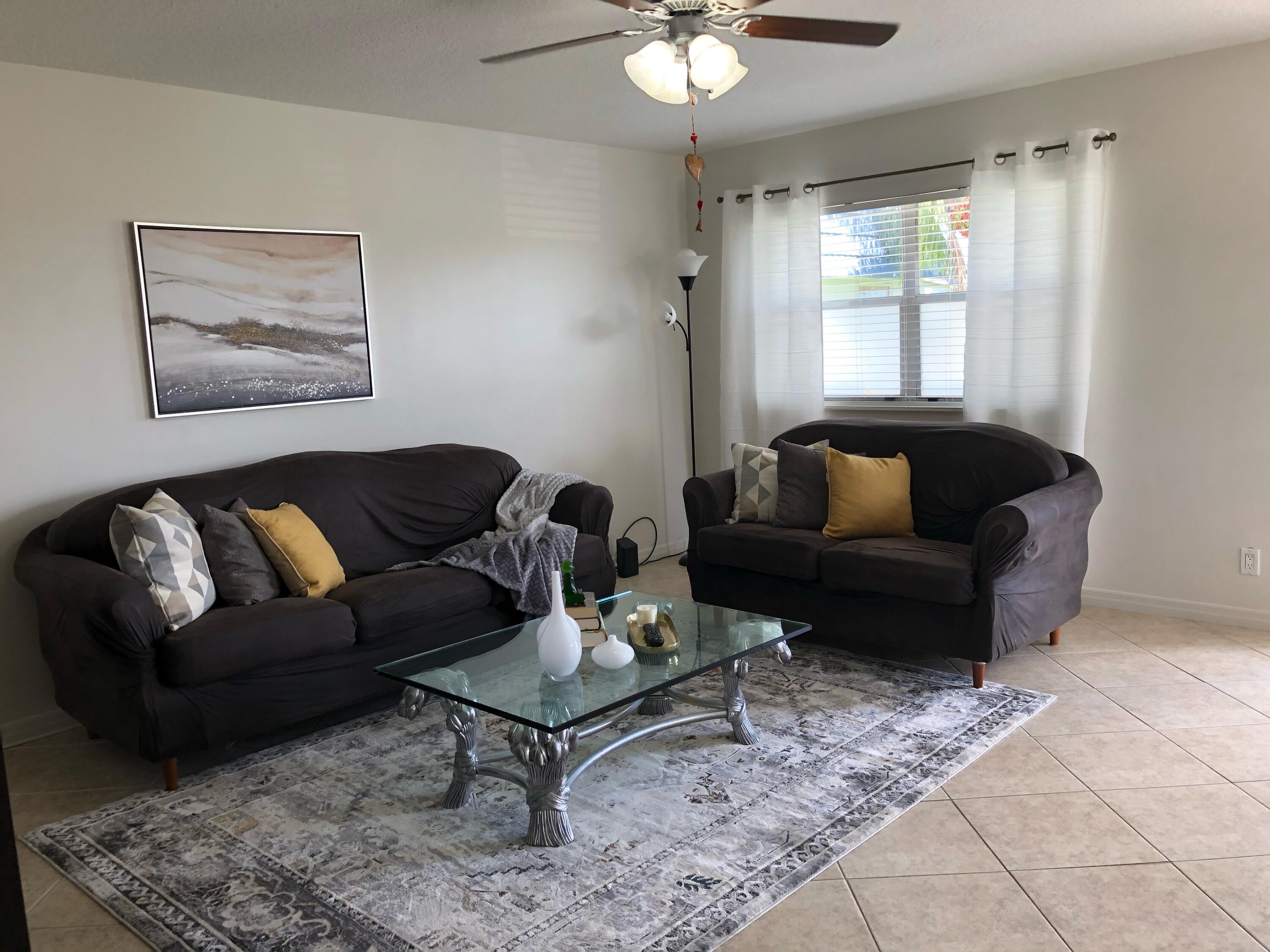 148 Tuscany Lane, Unit B Delray Beach, FL 33446 - Photo 4 of 11 a living room with furniture and a window