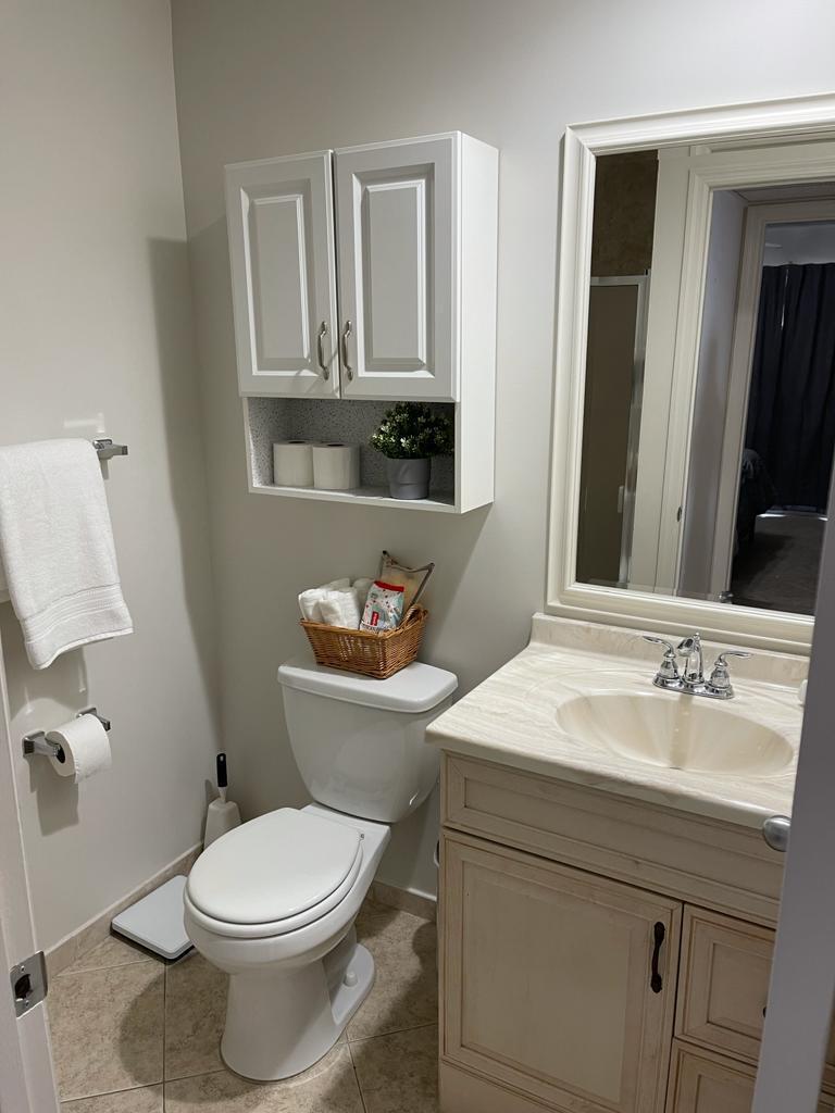 148 Tuscany Lane, Unit B Delray Beach, FL 33446 - Photo 7 of 11 a bathroom with a sink a toilet and mirror