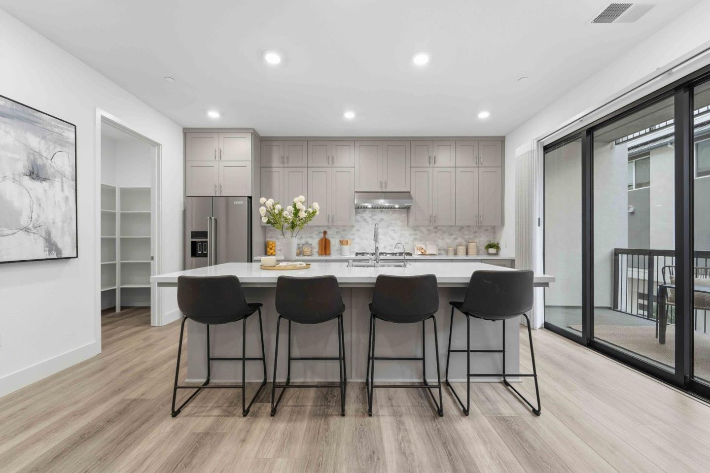 3465 Inspiration Way, Unit 201 Fremont, CA 94538 - Photo 2 of 39 a kitchen with stainless steel appliances kitchen island granite countertop a table chairs and a refrigerator