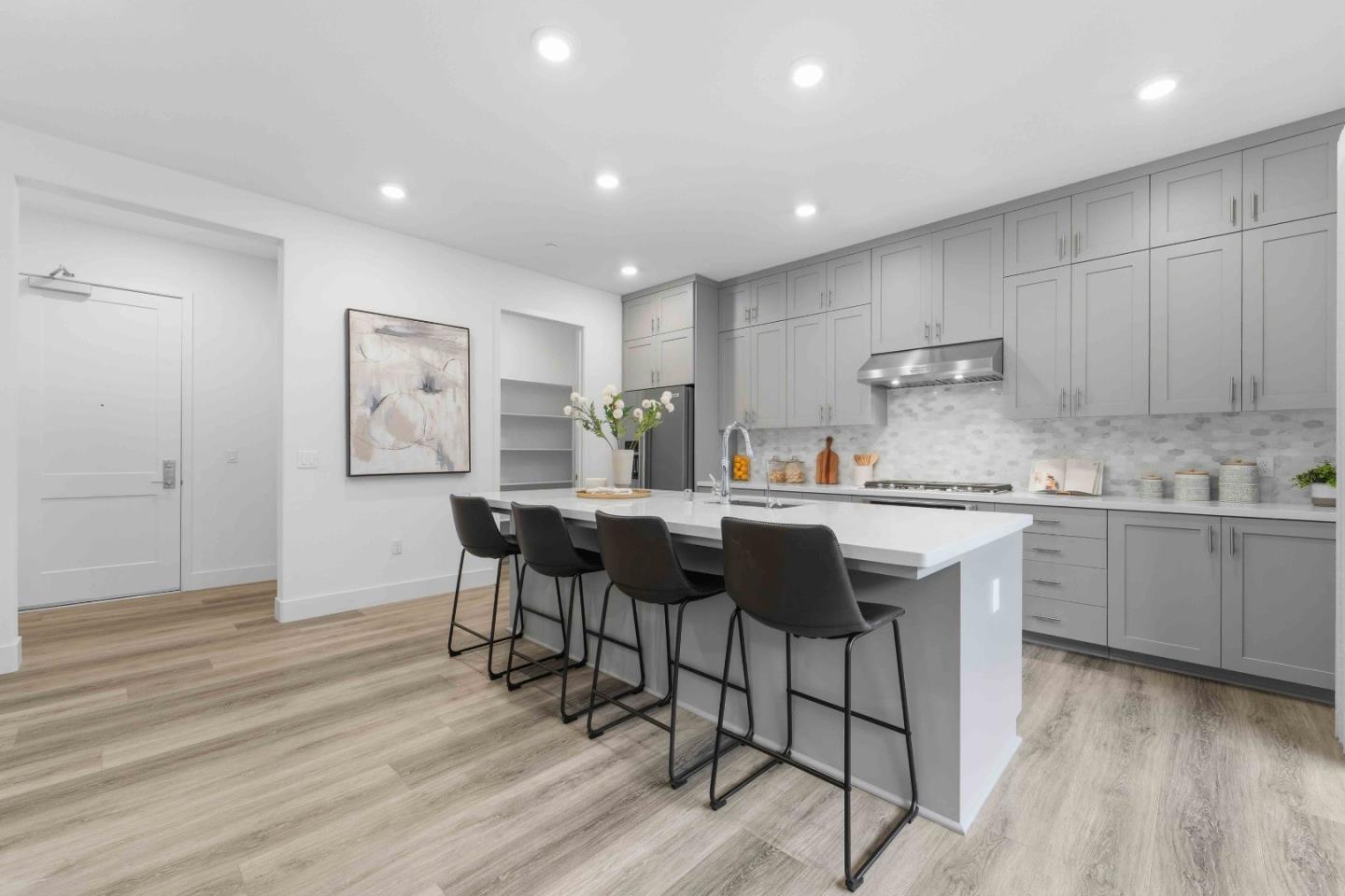 3465 Inspiration Way, Unit 201 Fremont, CA 94538 - Photo 3 of 39 a kitchen with kitchen island granite countertop a sink cabinets and wooden floor