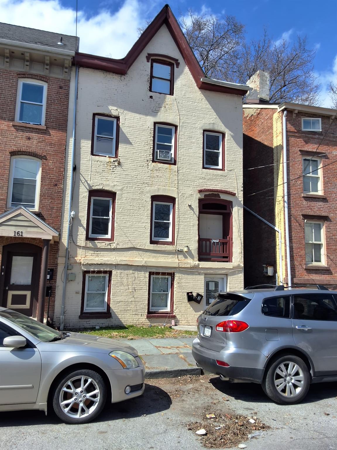 a car parked in front of a brick house