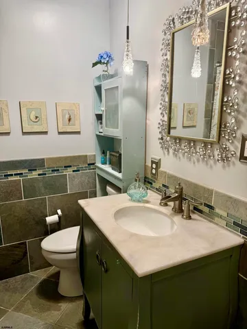 a bathroom with a sink a toilet and mirror