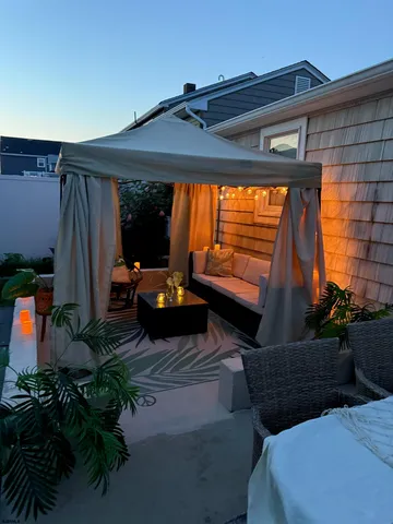 a backyard of a house with yard barbeque oven and outdoor seating