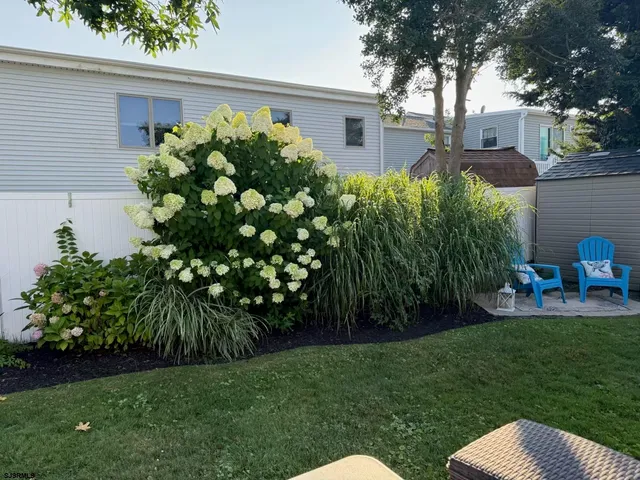 a backyard of a house with lots of green space and fountain