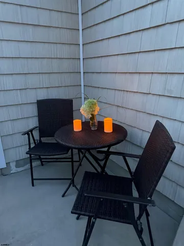 a view of a room with a table and chairs