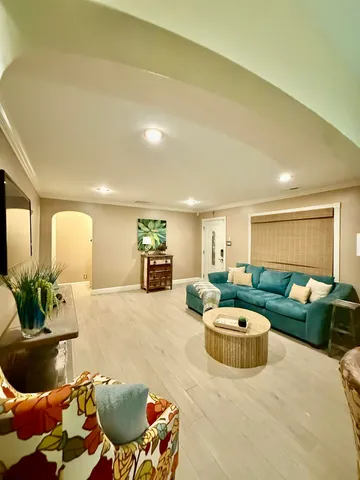 a living room with furniture and a potted plant