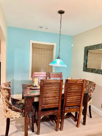 a view of a dining room with furniture and a chandelier