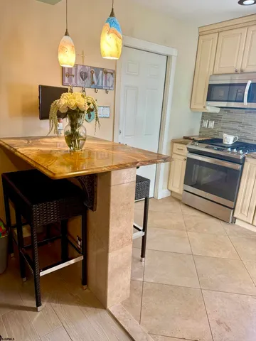 a room with table chairs and kitchen view