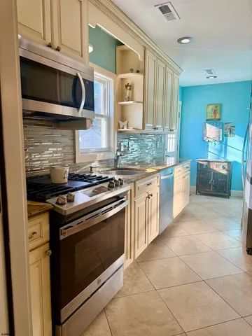 a kitchen with stainless steel appliances granite countertop a stove and a microwave