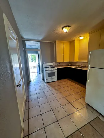a large kitchen with a stove a refrigerator a sink and dishwasher