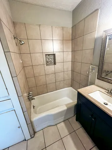 a bathroom with a sink a bathtub and shower