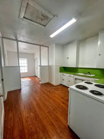 a kitchen that has a microwave and a stove