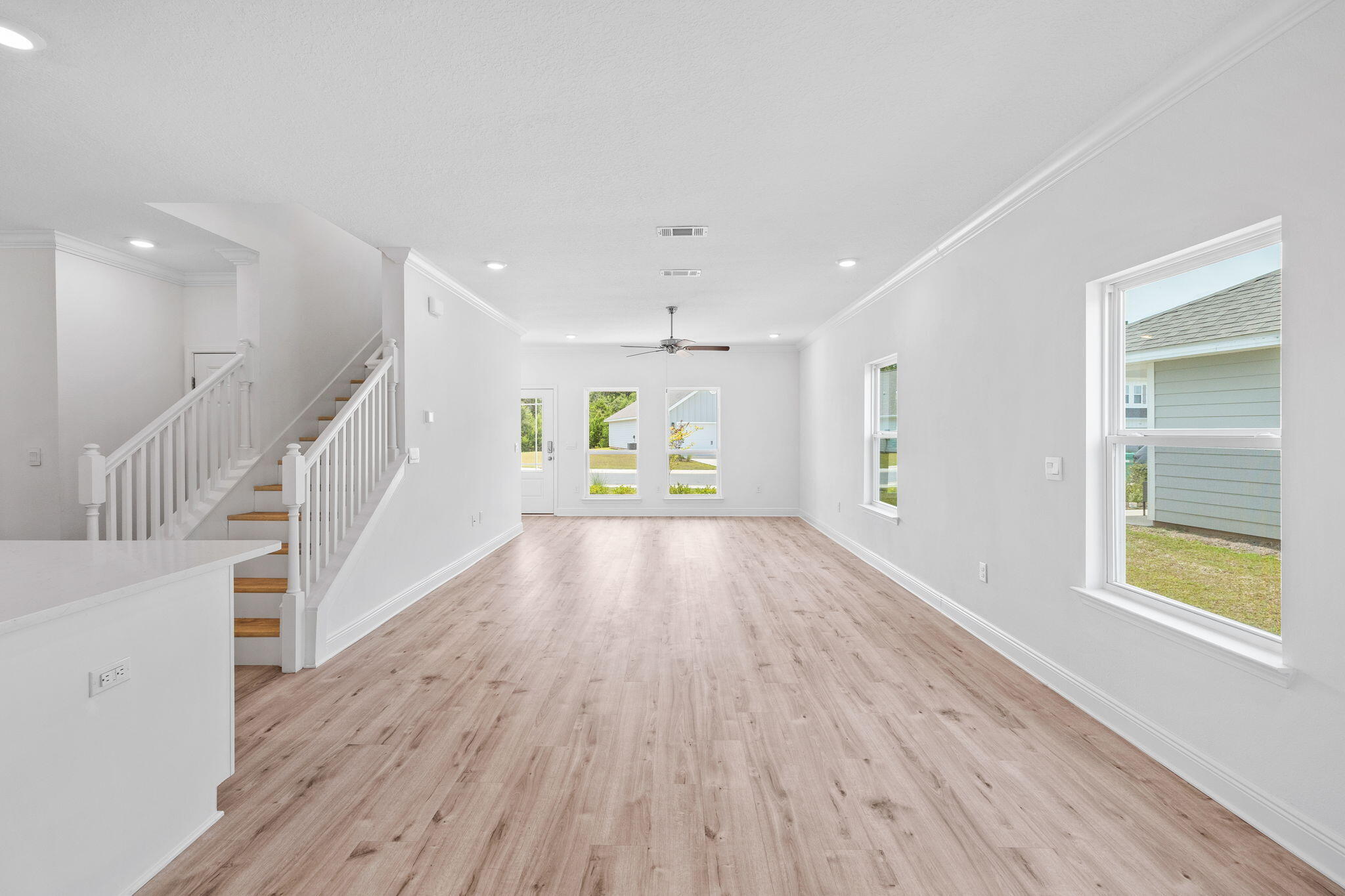 100 JRS Way Santa Rosa Beach, FL 32459 - Photo 11 of 74 a view of an empty room with wooden floor kitchen view and a window