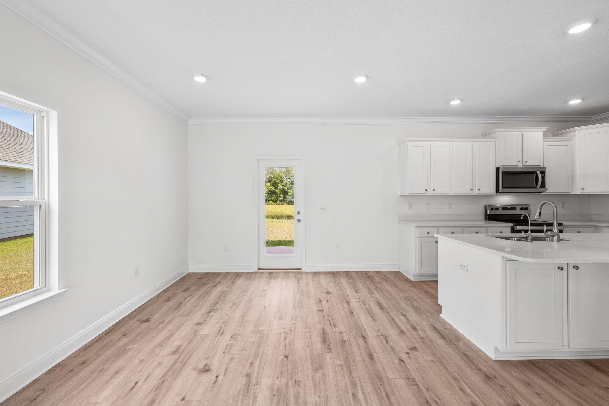 100 JRS Way Santa Rosa Beach, FL 32459 - Photo 15 of 74 a kitchen with wooden floors and appliances