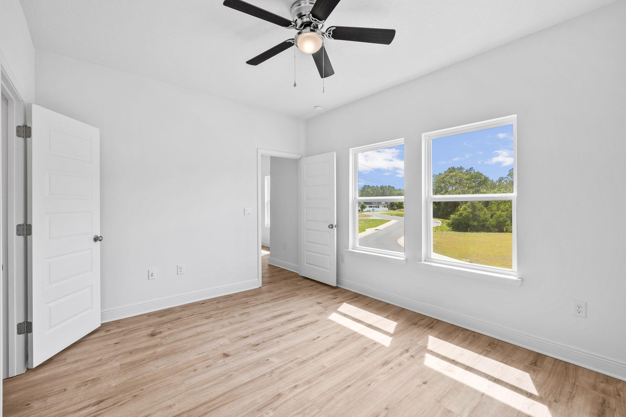 100 JRS Way Santa Rosa Beach, FL 32459 - Photo 25 of 74 a view of an empty room with a window and wooden floor